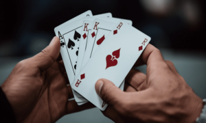 Ambcrypto an image of a person holding a few playing cards with 1643c342 d207 4bd8 bb1b 750e25d38dad 1200x900 1000x600.png