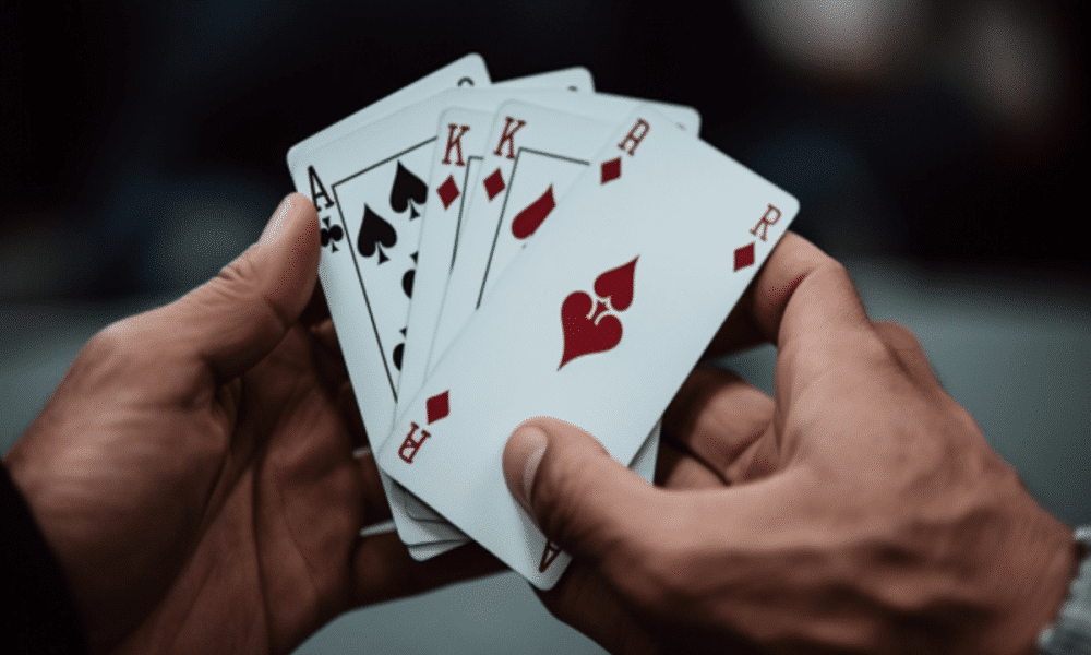 Ambcrypto an image of a person holding a few playing cards with 1643c342 d207 4bd8 bb1b 750e25d38dad 1200x900 1000x600.png