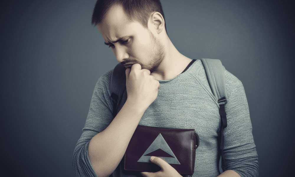 Ambcrypto an image of a man looking nervous and holding on tigh 7204bcc7 5980 4a92 b5cc 3f52778f49e6 1000x600.png